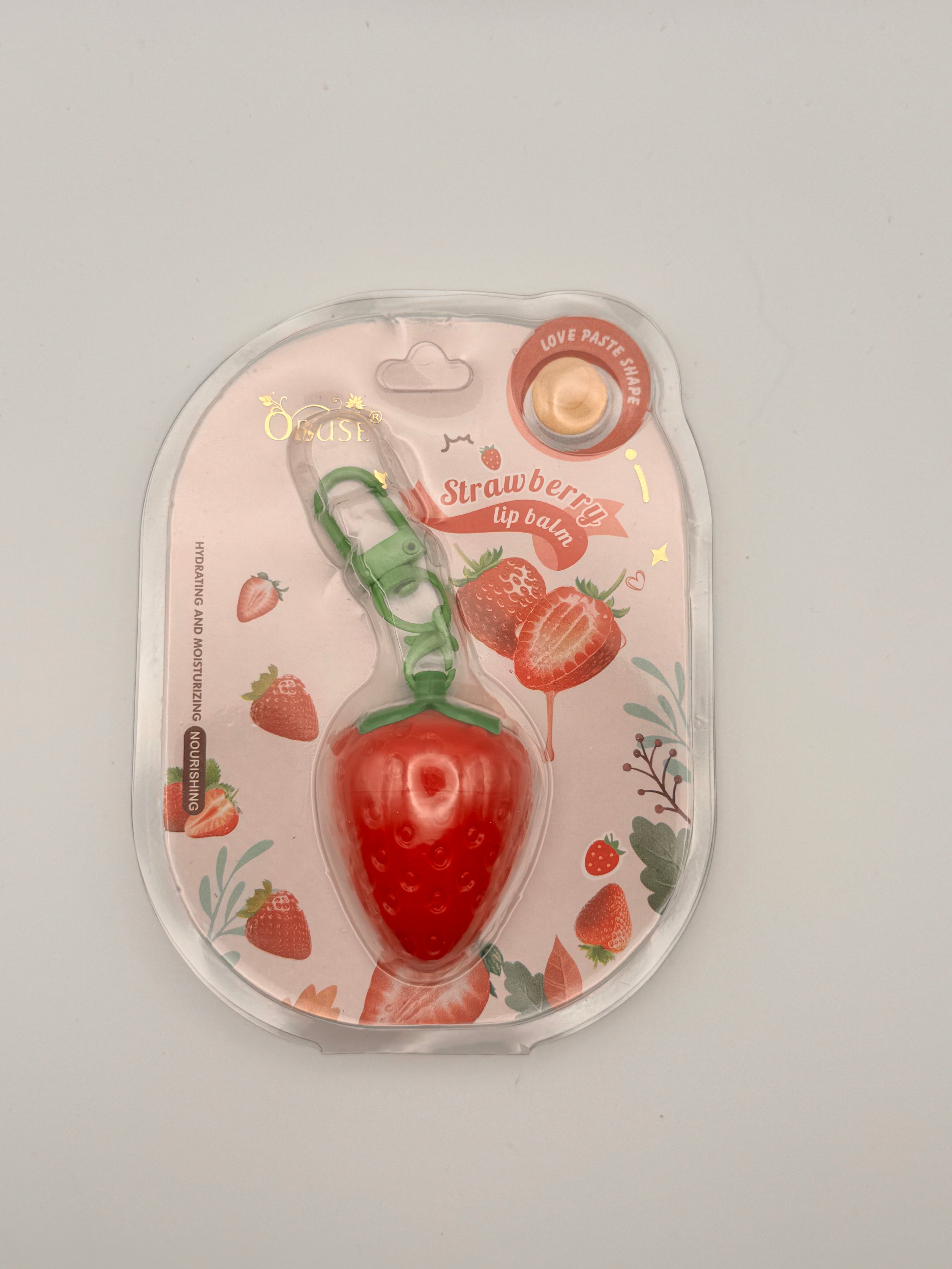 "Obuse Strawberry Magic Lip Balm - Thai moisturizing lip balm with strawberry extract, shea butter, and vitamin E for soft, plump, hydrated lips"
