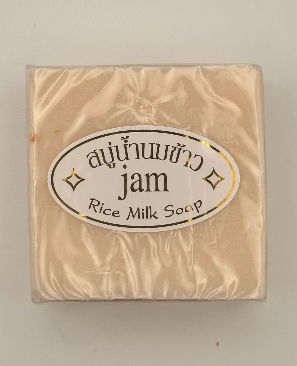 "Jam Rice Milk Soap bars unwrapped showing creamy rice milk texture for brightening face and body"
